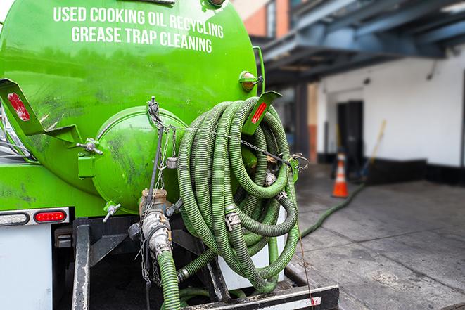 worker pumping grease trap at commercial kitchen in Belchertown MA